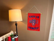 Load image into Gallery viewer, this is st mary's gaels country garden flag for college dorm decor hung inside a well-lit room