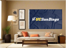 Load image into Gallery viewer, indoor display of blue uc san diego tritons flag for man cave decor
