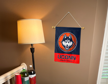 Load image into Gallery viewer, uconn basketball garden flag hung inside a room for college dorm decor