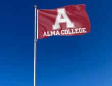 Load image into Gallery viewer, outdoor display of red alma college flag for tailgate decor