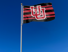 Load image into Gallery viewer, outdoor display of black and red university of utah flag with interlock uu logo for tailgate decor