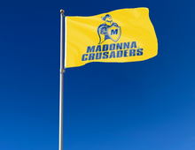 Load image into Gallery viewer, outdoor display of gold madonna university crusaders flag for tailgate decor