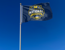 Load image into Gallery viewer, outdoor display of Michigan 2026 March Madness Basketball Champions Flag as part of tailgate decor