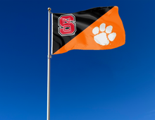 Load image into Gallery viewer, outdoor display of nc state clemson university house divided flag for tailgate decor