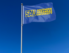 Load image into Gallery viewer, outdoor display of blue southern arkansas university flag for tailgate decor