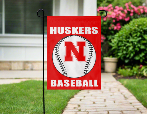 red nebraska baseball garden flag hung outside from a garden flag stand