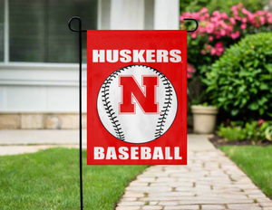 red nebraska baseball garden flag hung outside from a garden flag stand