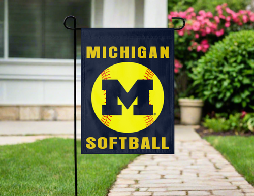 blue Michigan Softball garden flag in front of a house with a pathway and flowers.