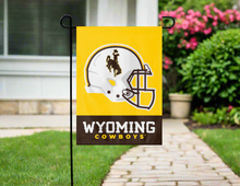 Load image into Gallery viewer, Wyoming Cowboys Football garden flag hung on garden flag stand outside
