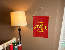 Load image into Gallery viewer, double sided Iowa state university garden flag hanging on banner pole inside living room
