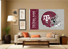 Load image into Gallery viewer, 3x5 Texas A&amp;M University Football Flag with two metal grommets covering tan wall of well lit room
