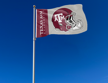 Load image into Gallery viewer, 3x5 Texas A&amp;M University Football Flag with two metal grommets attached to flagpole waving in the wind
