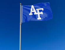 Load image into Gallery viewer, Blue 3x5 foot Air Force Academy Flag with AF Logo and Two metal grommets attached to flag pole swaying in the wind
