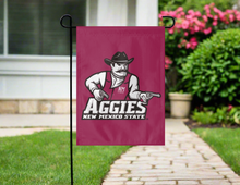 Load image into Gallery viewer, maroon new mexico state university garden flag hung outside from garden flag stand
