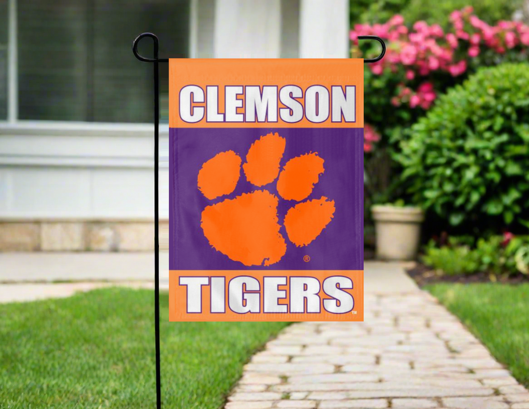 three panel orange and purple clemson garden flag hung outside from garden flag stand 