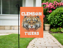 Load image into Gallery viewer, orange clemson garden flag with realistic tiger face logo hung outside from garden flag stand
