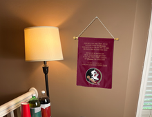 Load image into Gallery viewer, florida state fight song garden flag hanging on banner pole next to a lamp and drinks indoors
