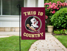 Load image into Gallery viewer, fsu garden flag with this is country logo hung outside on garden flag stand
