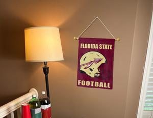 fsu football garden flag hung on a banner pole next to a lamp and drink