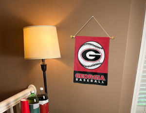 red and black Georgia Baseball Garden Flag hanging on banner pole inside living room
