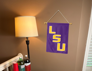 purple LSU Garden flag hanging on banner pole inside living room
