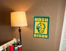 Load image into Gallery viewer, NDSU garden flag with bison logo hanging on banner pole inside room
