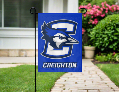 blue creighton university garden flag hung outside from garden flag stand
