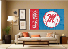 Load image into Gallery viewer, light blue and red 3x5 Ole Miss Baseball Flag with two metal grommets covering tan wall of well lit room
