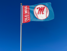Load image into Gallery viewer, light blue and red 3x5 Ole Miss Baseball Flag with two metal grommets attached to flagpole waving in the wind
