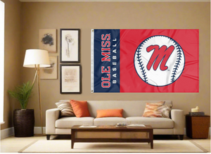 two panel blue and red Ole Miss Baseball Flag with two metal grommets covering tan wall of well lit room