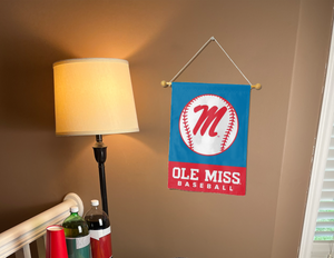 light blue ole miss baseball garden flag hanging on banner pole inside room