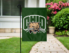 Load image into Gallery viewer, green ohio university garden flag hung outside from garden flag stand
