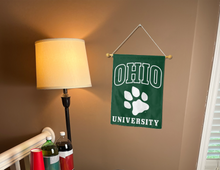 Load image into Gallery viewer, green ohio university garden flag hanging on banner pole inside living room
