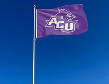 Load image into Gallery viewer, Purple 3x5 foot wide Abilene Christian University ACU flag hung on a flag pole swaying in the wind

