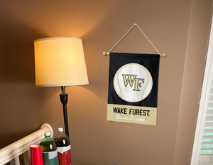 Wake Forest baseball garden flag hanging on banner pole inside living room