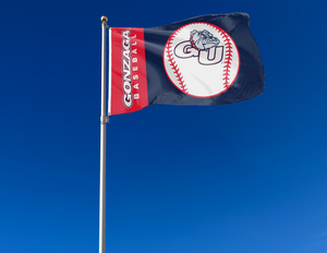 Blue and red 3x5 Gonzaga Baseball flag with two metal grommets attached to flagpole waving in the wind