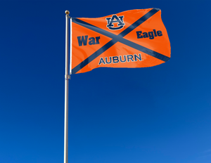 Orange 3x5 Auburn Flag with Auburn War Eagle Logo and Two Metal Grommets attached to a flagpole waving in the wind