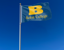 Load image into Gallery viewer, Blue 3x5 foot wide Beloit College Flag with two metal grommets attached to flagpole waving in the wind
