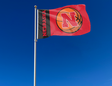 Load image into Gallery viewer, Black and Red 3x5 Nebraska Basketball Flag attached to flagpole waving in the wind

