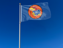 Load image into Gallery viewer, 3x5 University of Kansas Basketball Flag with two metal grommets attached to flagpole waving in the wind
