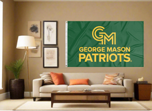 Load image into Gallery viewer, 3x5 George Mason University Flag with two metal grommets for indoor home décor covering tan wall of well lit room
