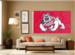 Red Fresno State University Flag with Bulldog Wearing American Flag Shirt and two metal grommets covering tan wall of well lit room