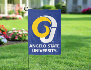 Blue 13x18 inch long Angelo State Garden flag hung on a black garden flag stand in front of a green yard with flowers on the left side