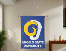 Load image into Gallery viewer, Blue 30x40 inch long Angelo State University House Flag hung on a banner pole in front of a gray well-lit living room wall

