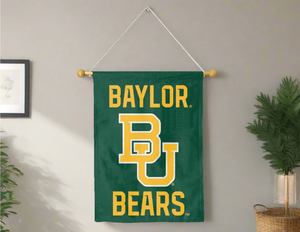 Green 30x40 inch long Baylor University House Flag hanging on banner pole covering a grey living room wall