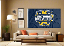 Load image into Gallery viewer, Blue University of Michigan 2023 College Football Playoffs National Champions 3x5 Flag with two metal grommets for indoor home decor covering tan wall of man cave
