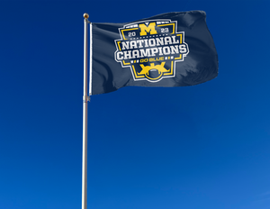 Blue University of Michigan 2023 College Football Playoffs National Champions 3x5 Flag with two metal grommets attached to flagpole waving in the wind