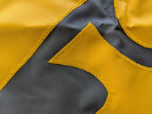 Load image into Gallery viewer, Close-up of a section of a yellow and black University of Iowa National Applique flag, showing the detailed stitching and fabric texture.
