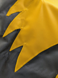 Close-up of a section of a gold and black University of Iowa National Applique flag, showing the detailed stitching and fabric texture.