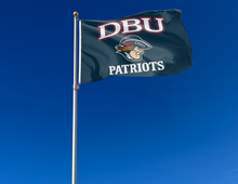 Load image into Gallery viewer, Blue 3x5 foot wide Dallas Baptist University Flag with DBU Patriots logo and two metal grommets attached to flagpole waving in the wind
